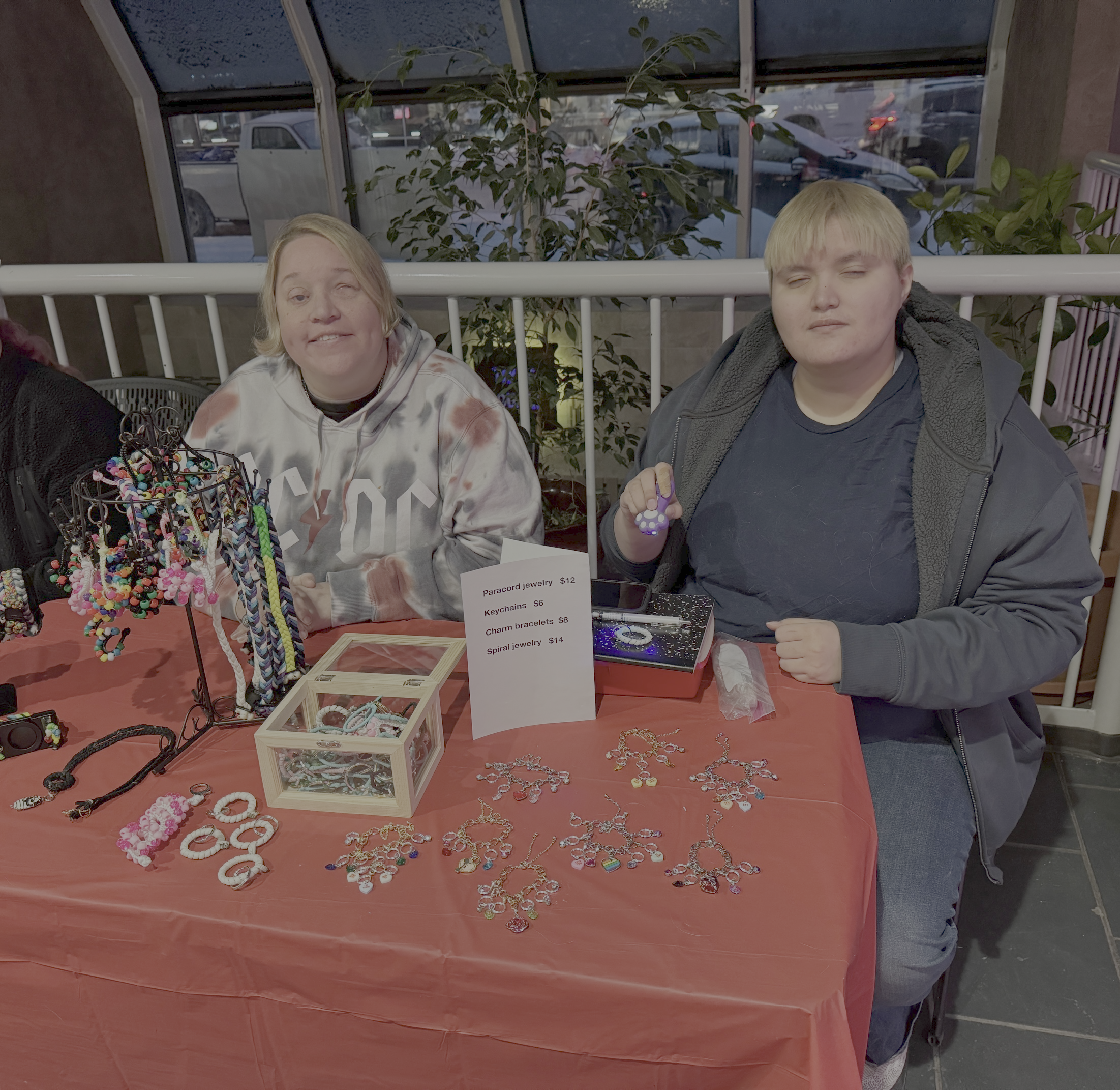 Phoenix and Satin sitting at their table during the Valentine's Day event