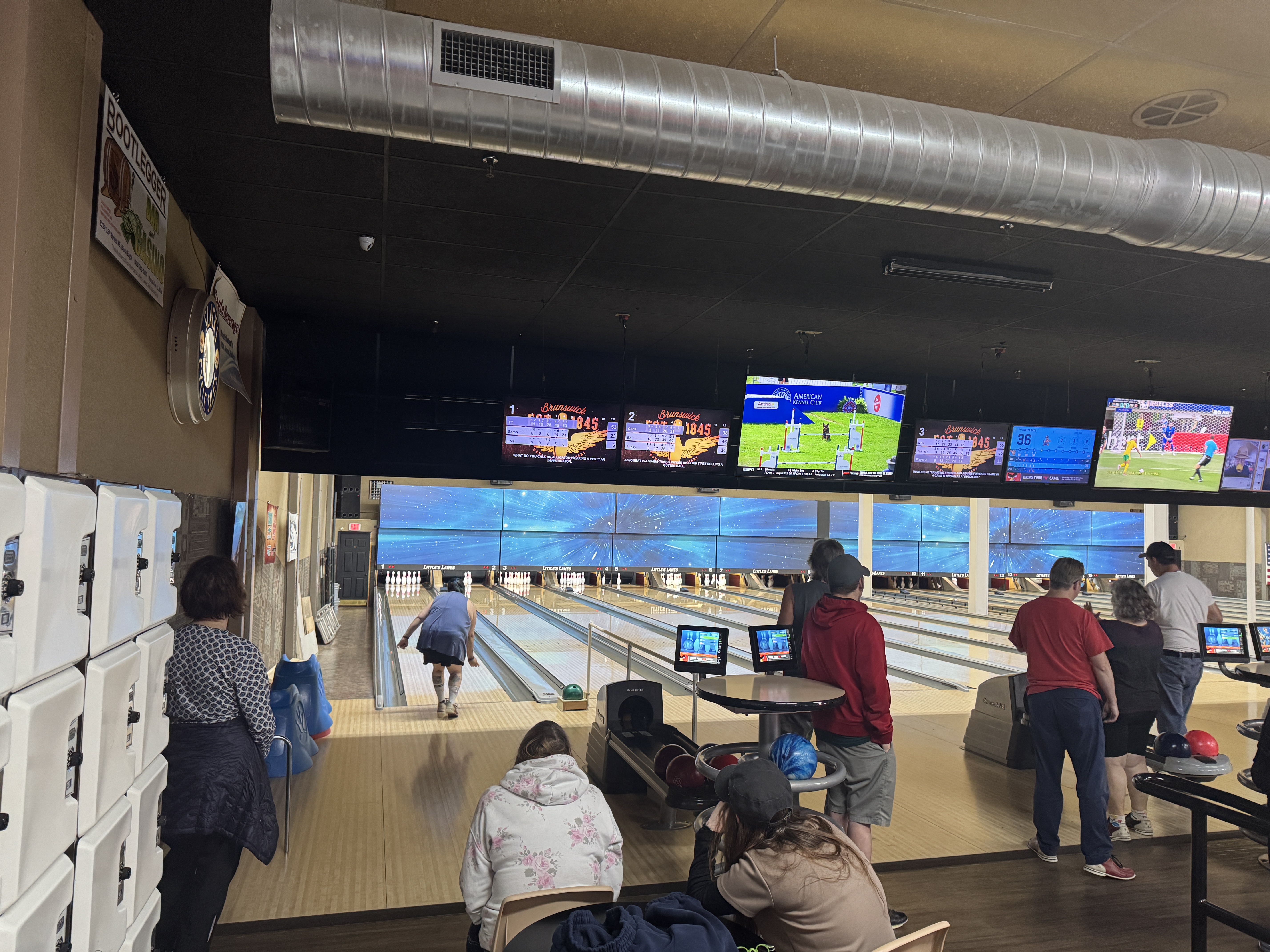 a group outing of students and staff members bowling, at a local alley.
