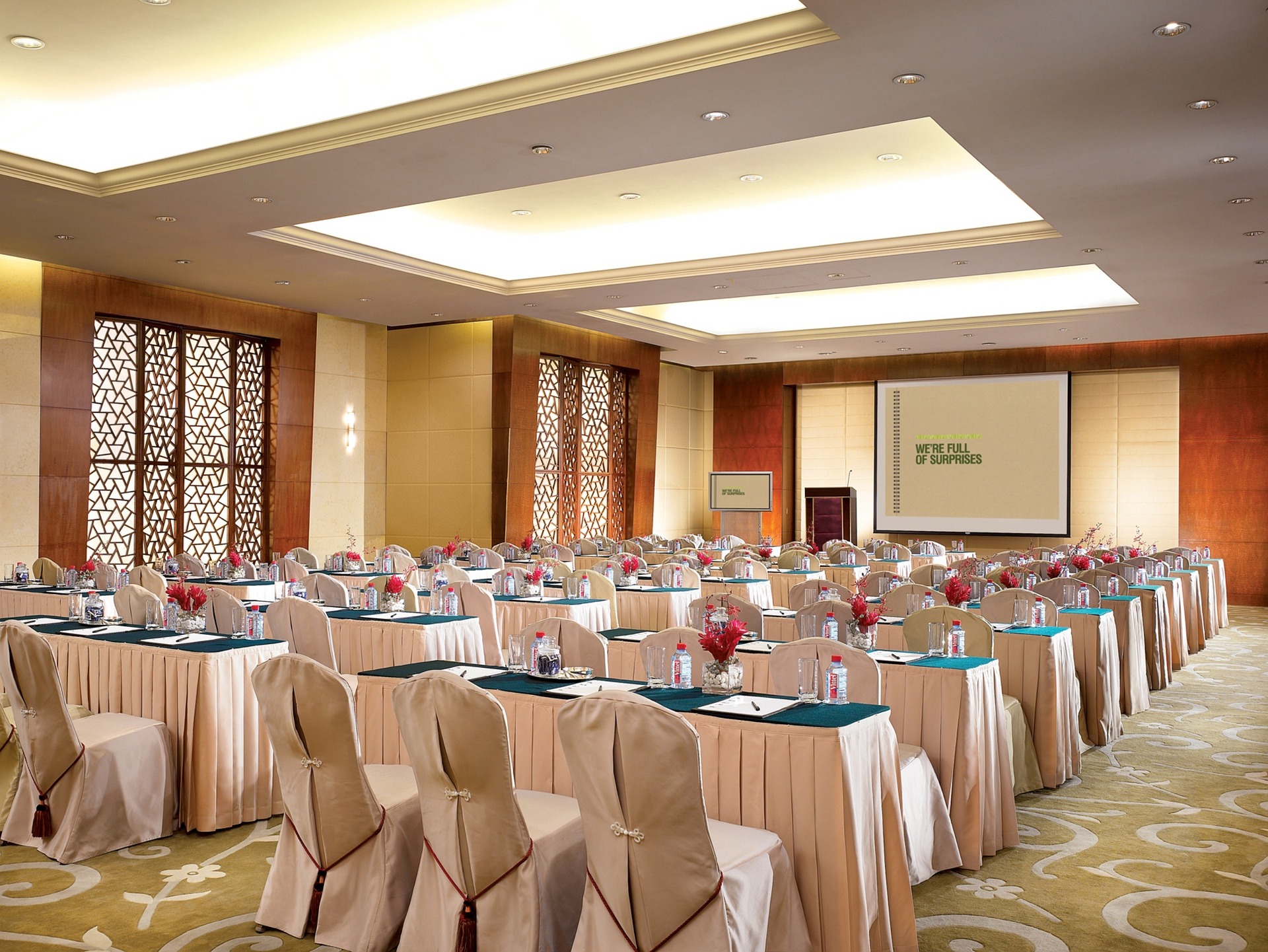 A empty meeting room, set up with tables and chairs.